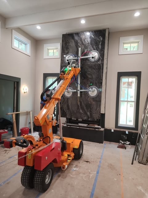 Large format stone slab installation on fireplace surround